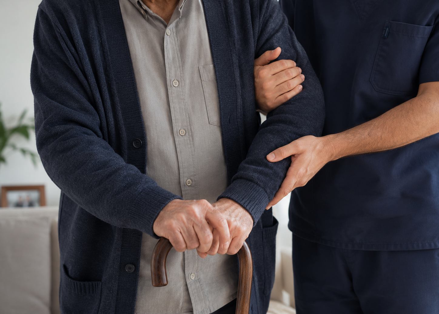 A caregiver supporting a senior using a walking cane
